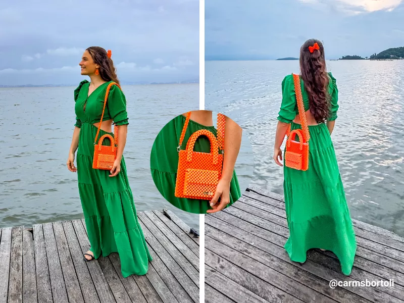 Mulher com vestido verde e bolsa laranja na praia