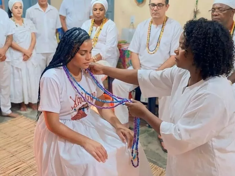 Cerimônia de culto com pessoas usando roupas brancas
